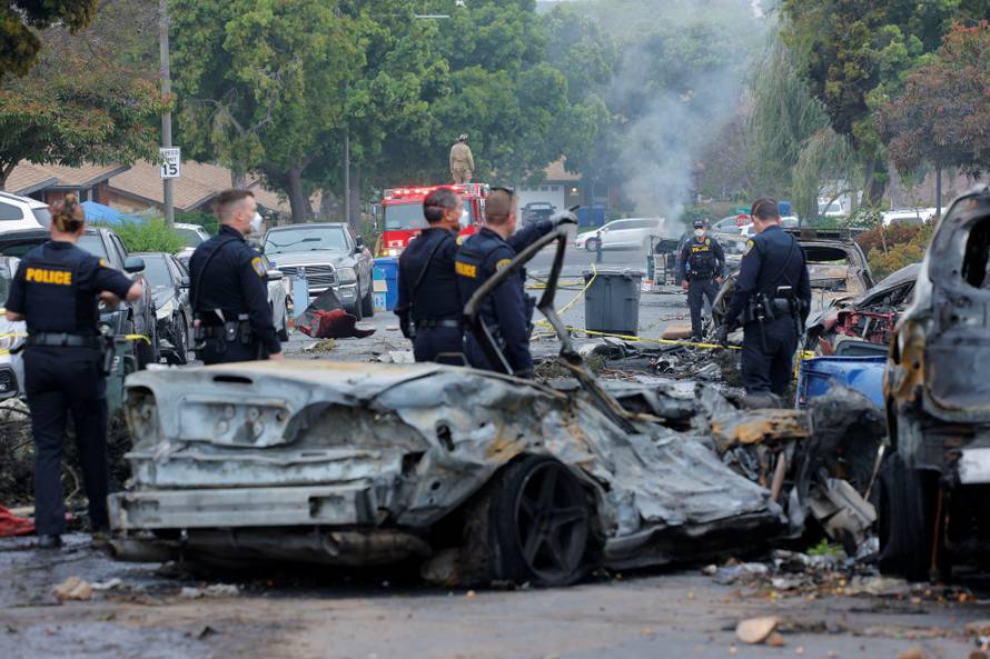 Crash scene after a civilian aircraft went down in a military neighborhood, in San Diego