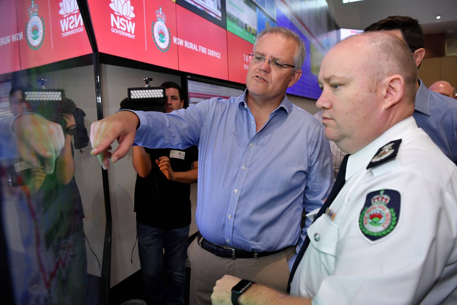 Australia's Prime Minister Scott Morrison is briefed by NSW RFS Commissioner Shane Fitzsimmons in the NSW Rural Fire Service control room in Sydney