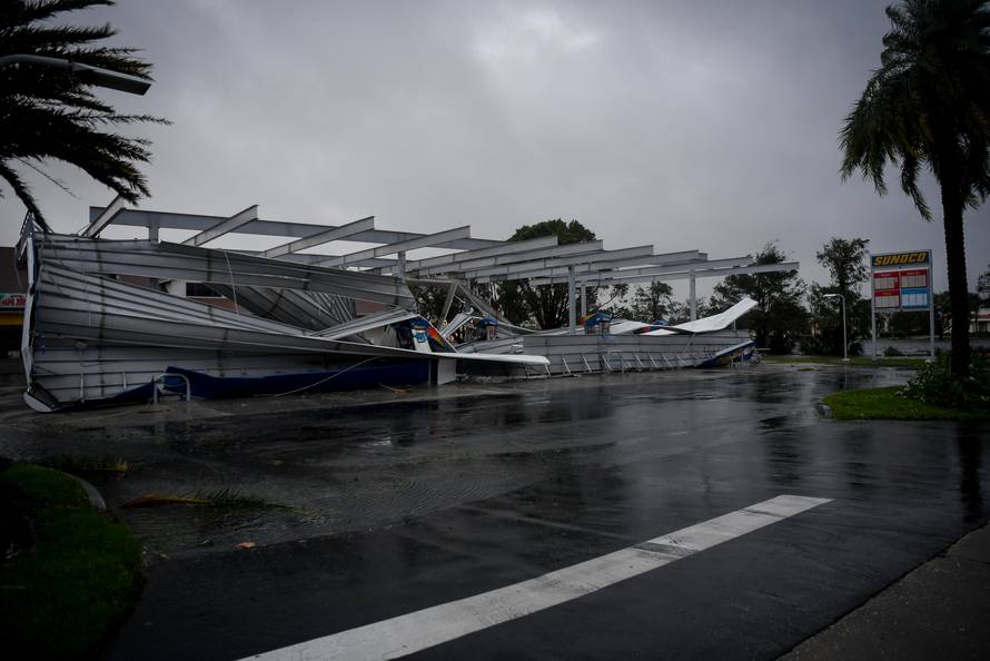 The crumbled canopy of a gas station damaged by Hurricane Irma is seen in Bonita Springs