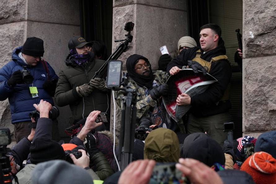 People attend the "March Against Minnesota Fraud" in Minneapolis