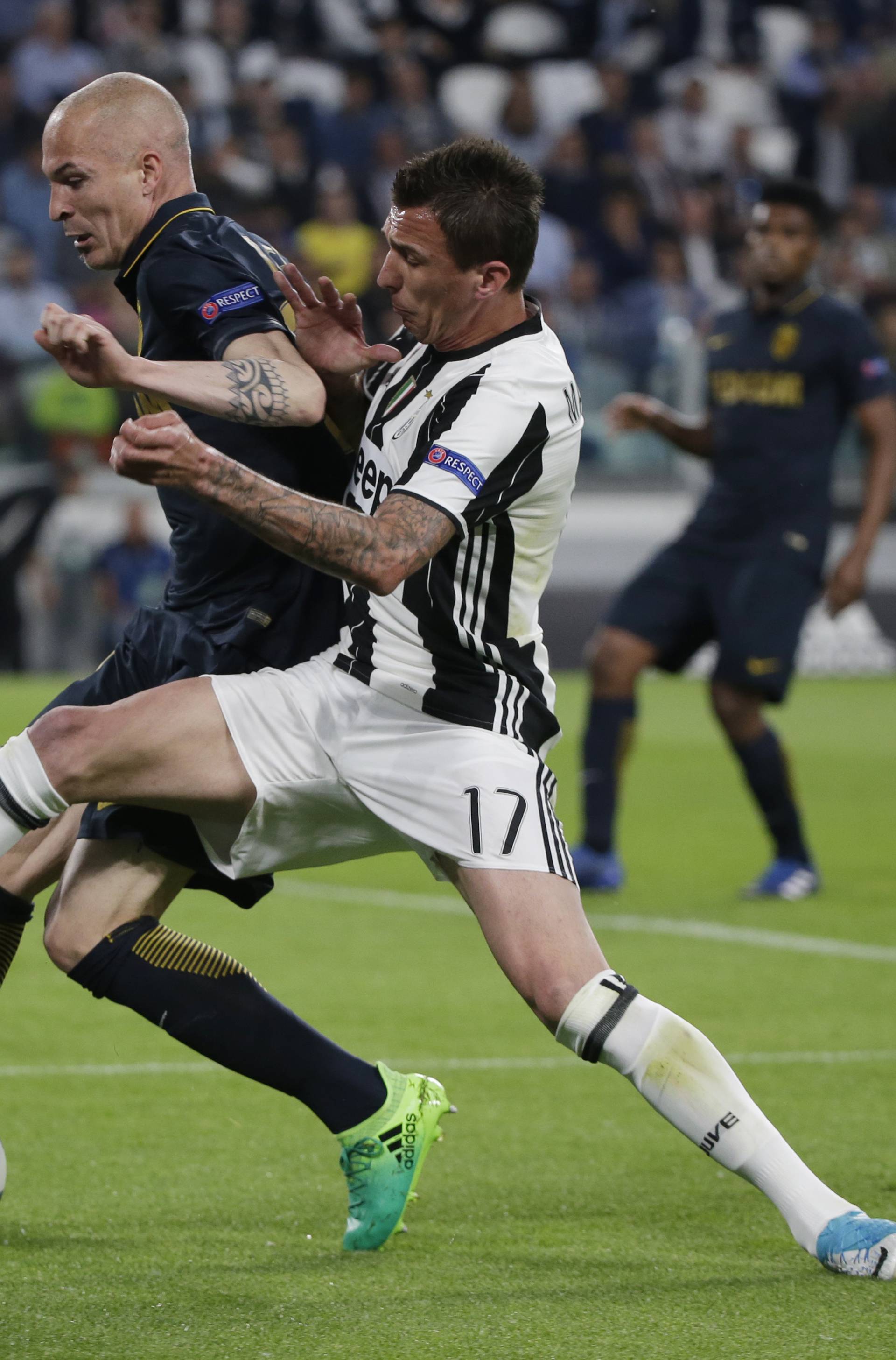 Monaco's Andrea Raggi in action with Juventus' Mario Mandzukic