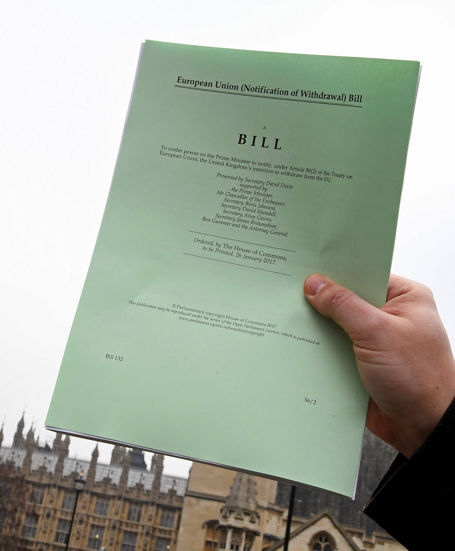 FILE PHOTO: A journalist poses with a copy of the Brexit Article 50  bill, introduced by the government to seek parliamentary approval to start the process of leaving the European Union, in London