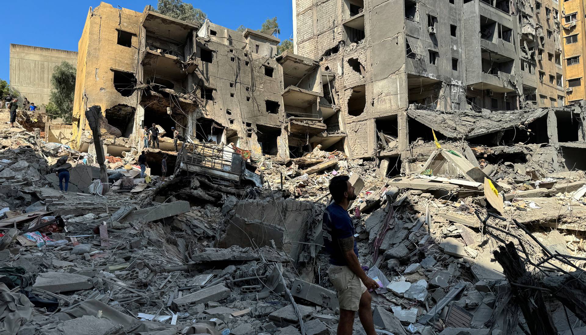 A man stands at the site of the Israeli air strike that killed Lebanon's Hezbollah leader Sayyed Hassan Nasrallah on Friday, in Beirut's southern suburbs