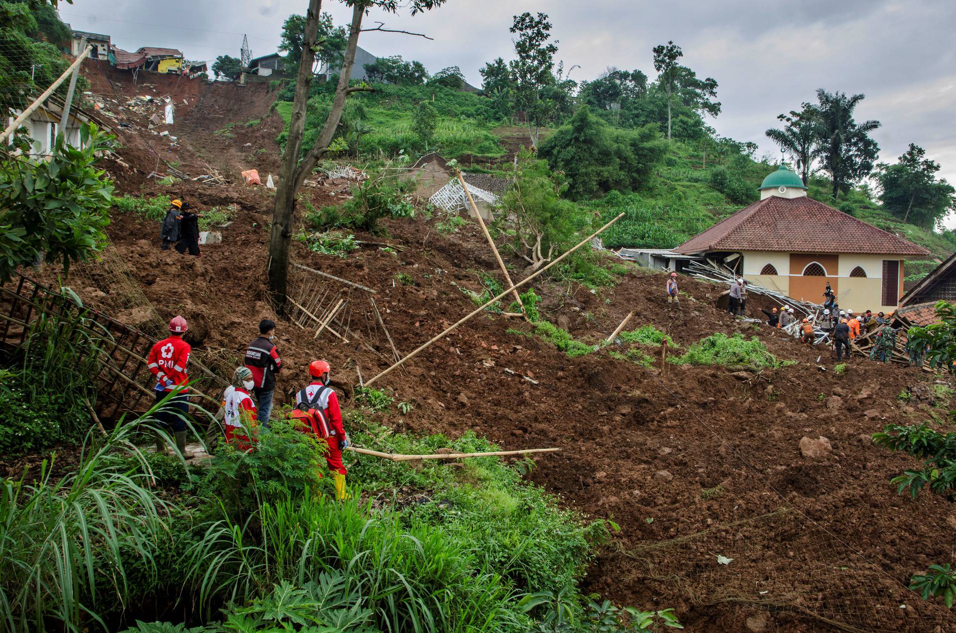 Indonesian Red Cross search for victims buried by landslides in Sumedang