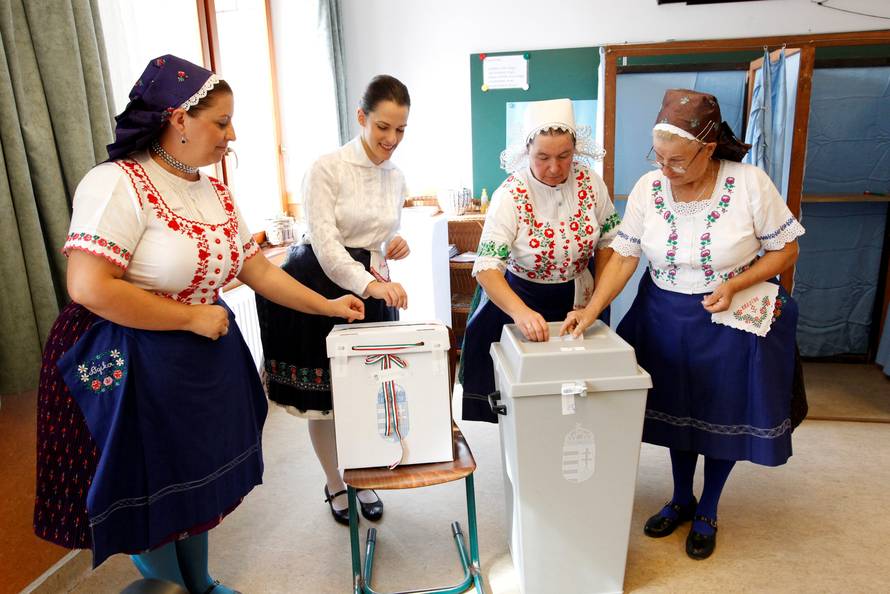 Hungarian women wearing traditional costumes attend a referendum on EU migrant quotas in Veresegyhaz