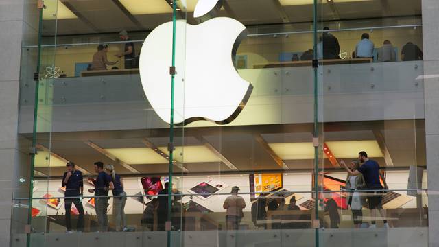 Customers and employees are shown through Apple's Australian flagship store in Sydney