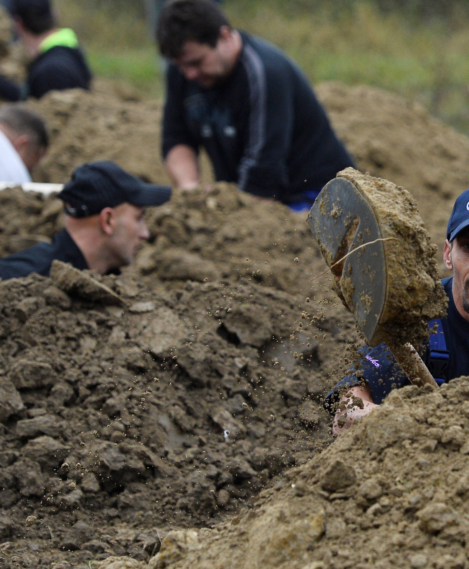 Gravediggers compete during a grave digging championship in Trencin