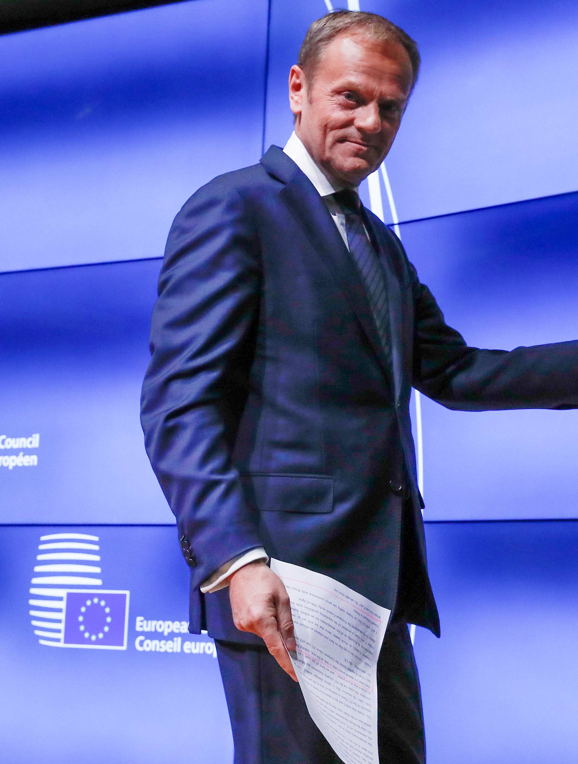 European Council President Donald Tusk shows British Prime Minister Theresa May's Brexit letter in notice of the UK's intention to leave the bloc under Article 50 of the EU's Lisbon Treaty, at the end of a news conference in Brussels