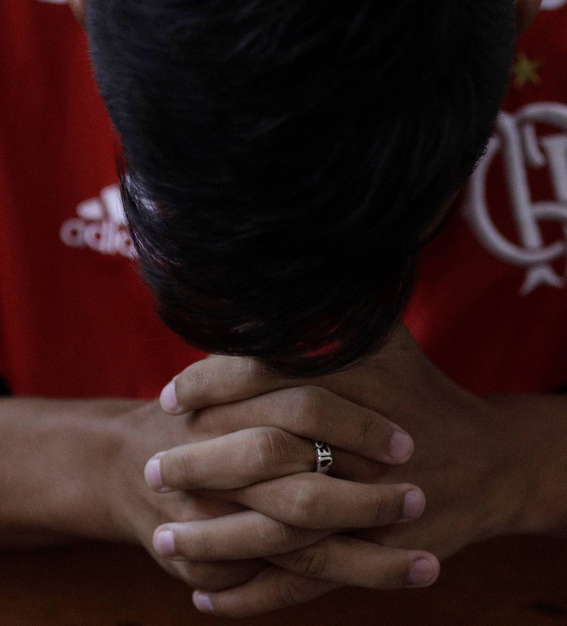 Flamengo's youth soccer player reacts during a mass in memory of the victims of the club's training center deadly fire in Rio de Janeiro