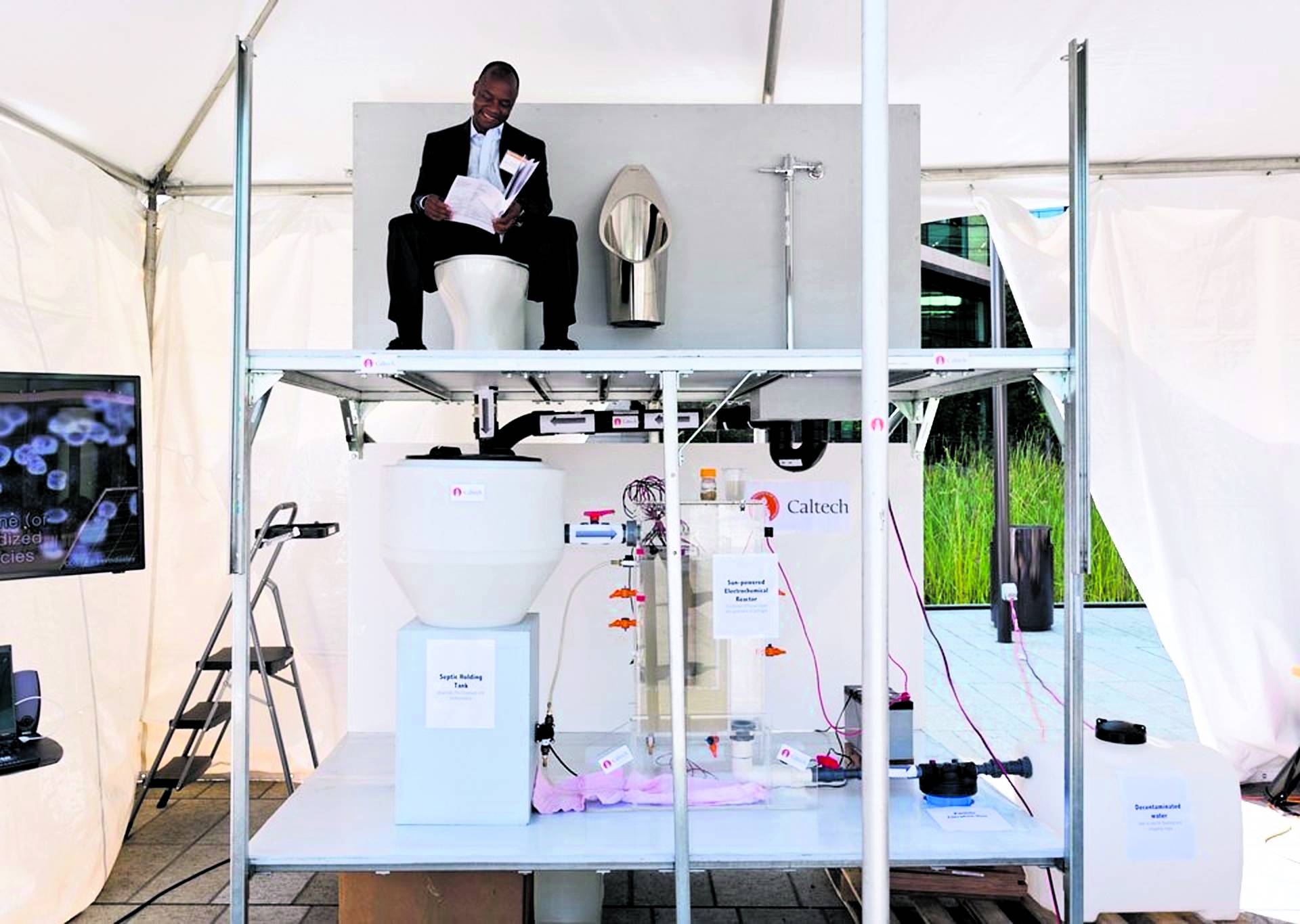 Doulaye Kone sits on the toilet at the winning prototype, a system designed by researchers from California Institute of Technology (exhibit 30) at the Reinvent the Toilet Fair in Seattle on August 12, 2012. Their model is a solar-powered toilet that gener