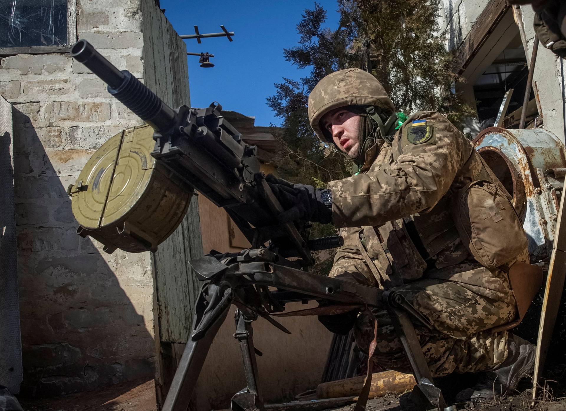 A Ukrainian serviceman fires an automatic grenade launcher in Bakhmut