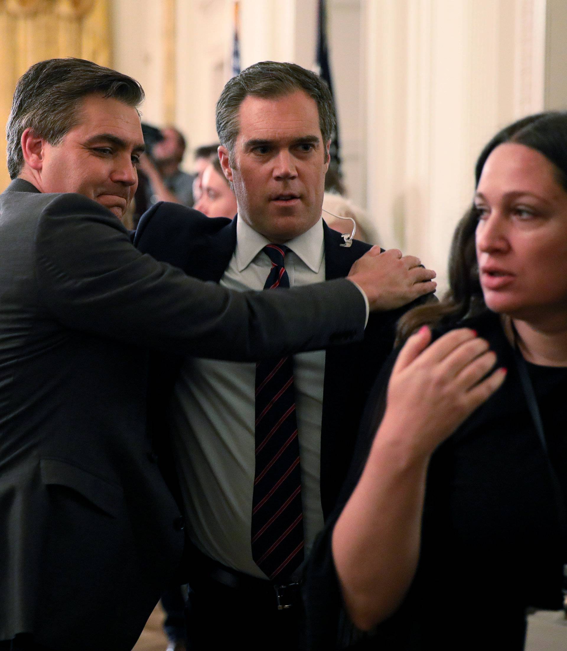 CNN's Acosta hugs colleague Alexander of NBC after tense exchange with U.S. President Trump during news conference at White House in Washington