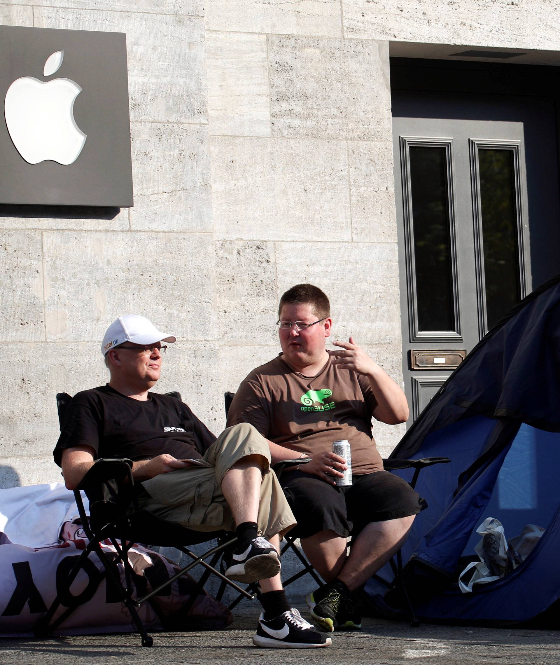 Customers wait beside their tents outside an Apple store to buy the newly released Apple iPhone 7 in Berlin