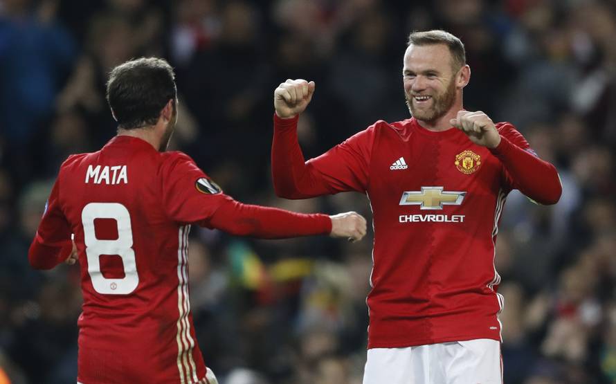 Manchester United's Juan Mata celebrates scoring their second goal  with Wayne Rooney