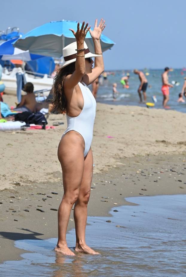 American actress Eva Longoria wows in a white swimsuit while pictured relaxing on the beach with her son Santiago Enrique Bastón in Marbella.