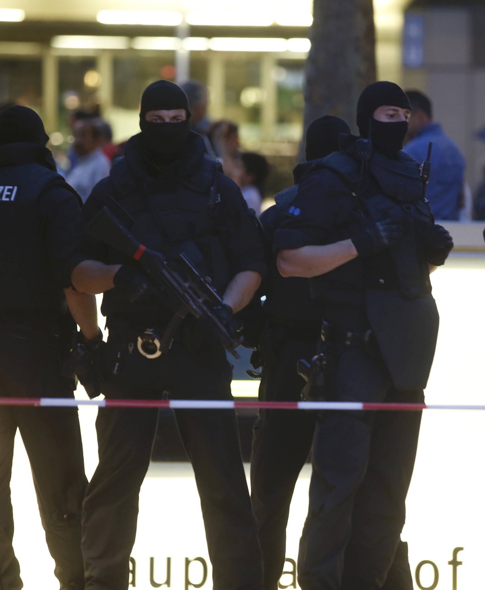 Special force police officers stand guard at entrance of main train station following shooting rampage at shopping mall in Munich