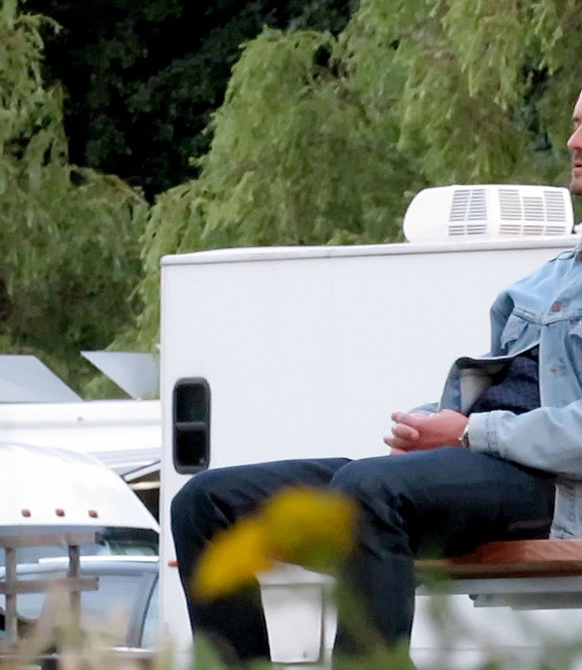 EXCLUSIVE: Orlando Bloom closes his eyes and gathers his thoughts on a park bench in Canada