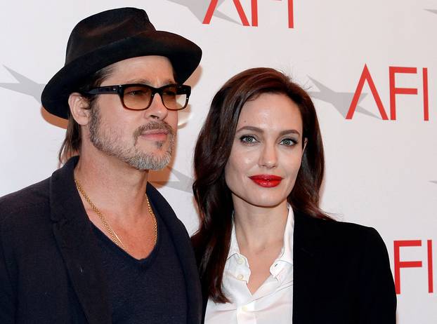 FILE PHOTO: Actor Brad Pitt and actress/director Angelina Jolie pose at the AFI Awards 2014 honoring excellence in film and television in Beverly Hills