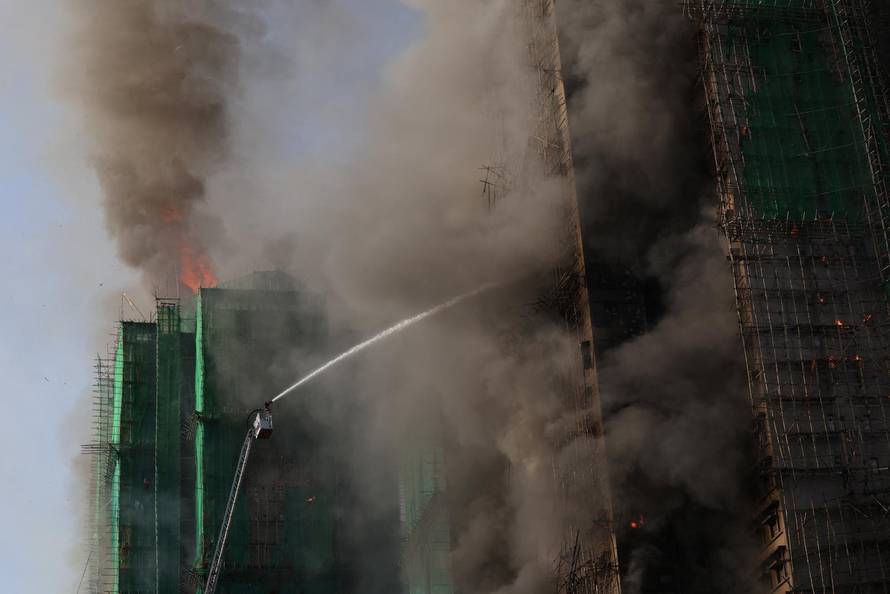 Flames engulf bamboo scaffolding across multiple buildings at Wang Fuk Court housing estate, in Tai Po
