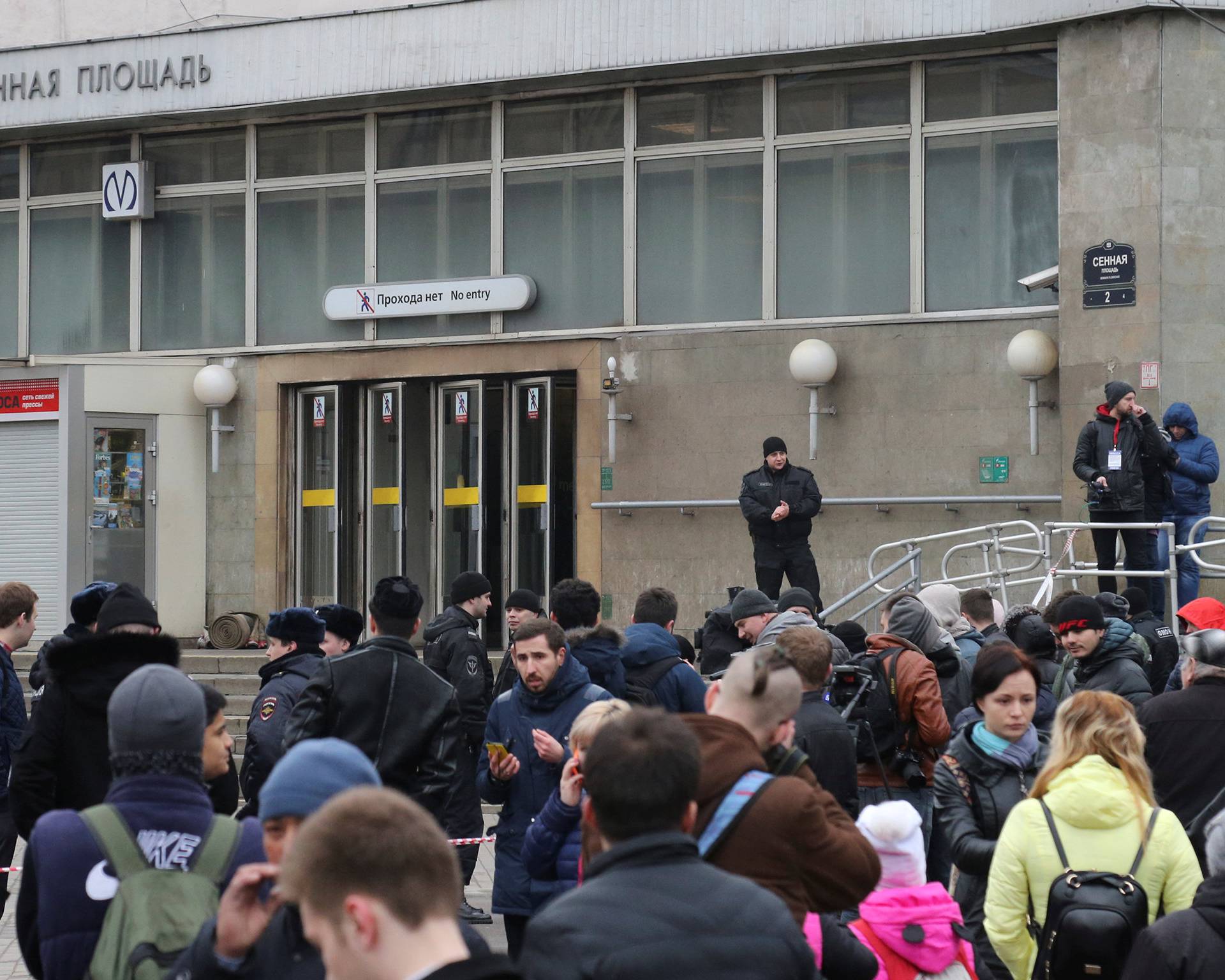 People gather outside Sennaya Ploshchad metro station after explosion tore through train carriage in St. Petersburg metro system, in St. Petersburg