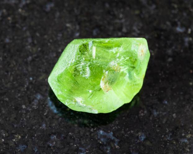 unpolished Olivine (Peridot, Chrysolite) on black