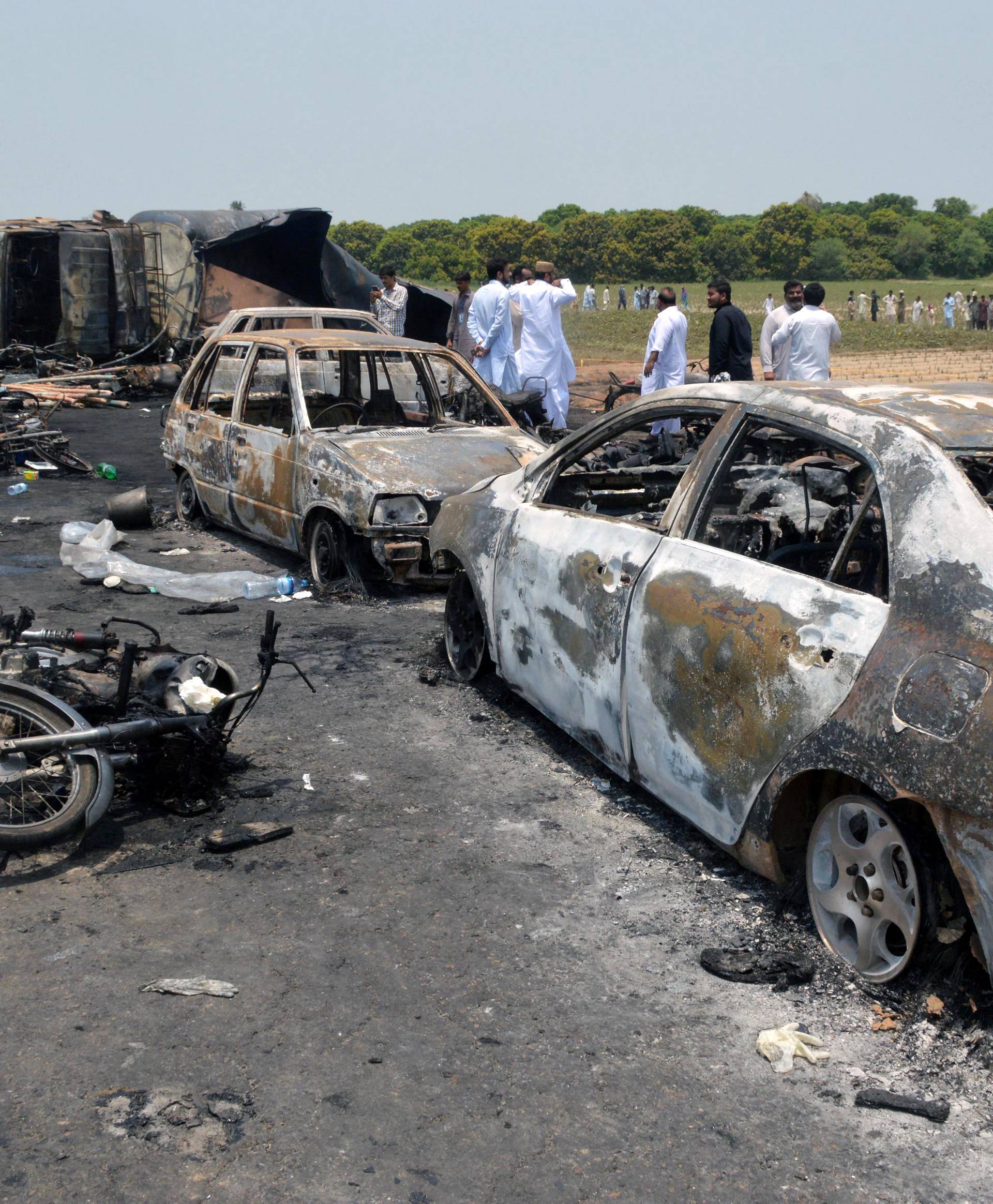 Burnt out cars and motorcycles are seen at the scene of an oil tanker explosion in Bahawalpur