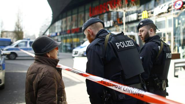 Police talk to a woman at the entrance of Limbecker Platz shopping mall in Esse