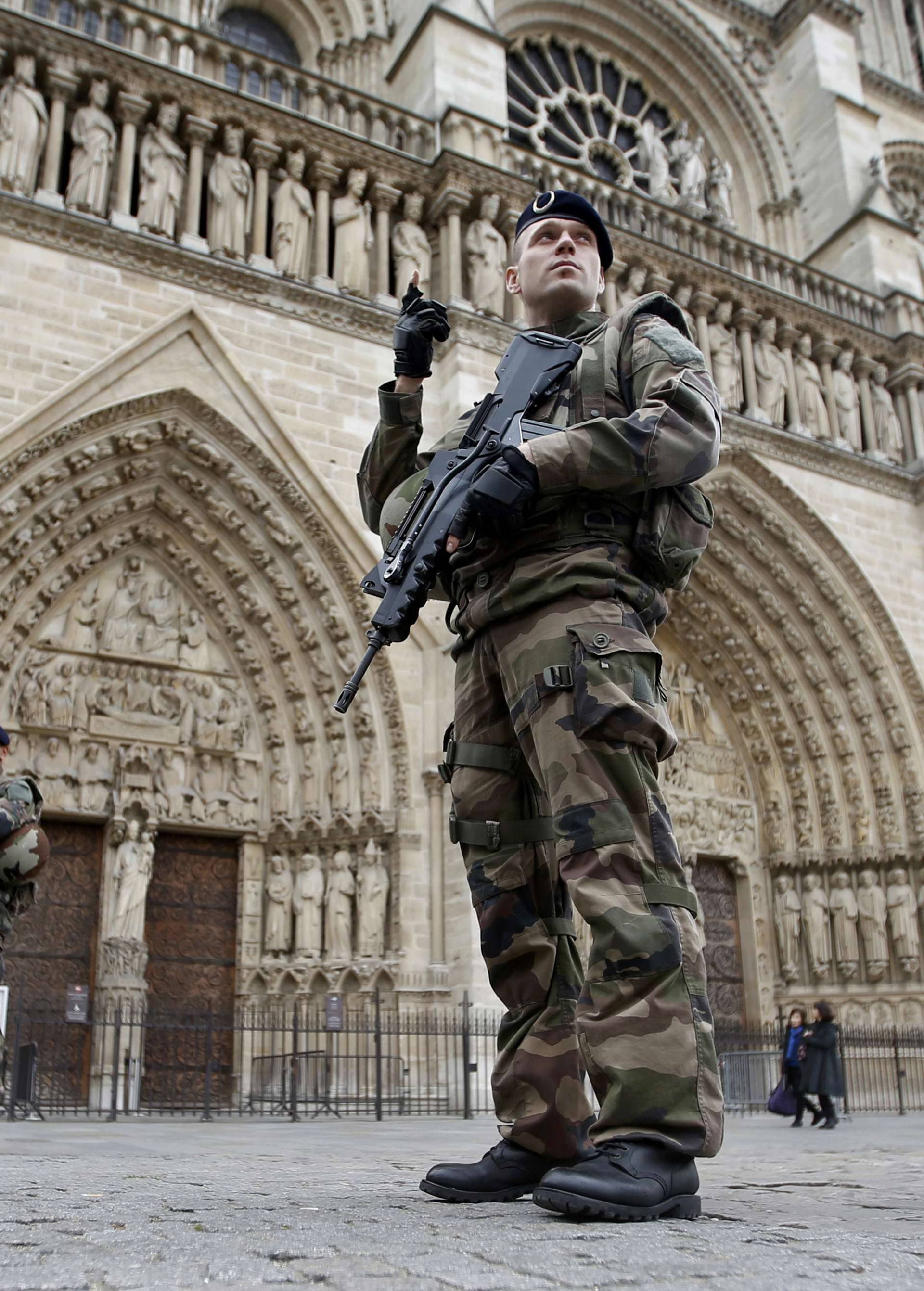 Soldiers patrol in front of the Notre Dame Cathedral in Paris