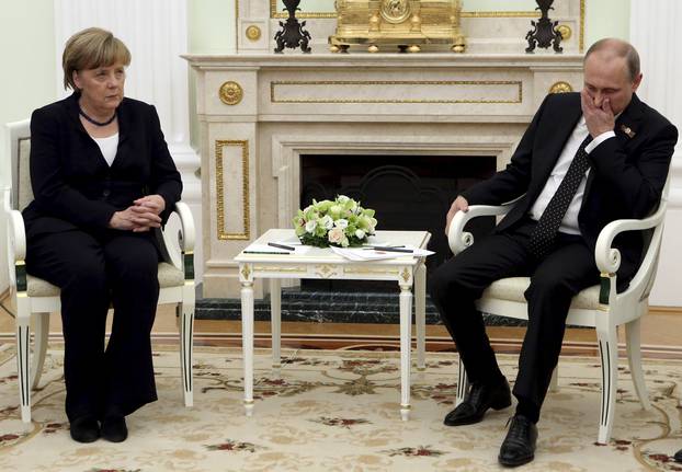 File photo of Russian President Vladimir Putin meeting with German Chancellor Angela Merkel at the Kremlin in Moscow