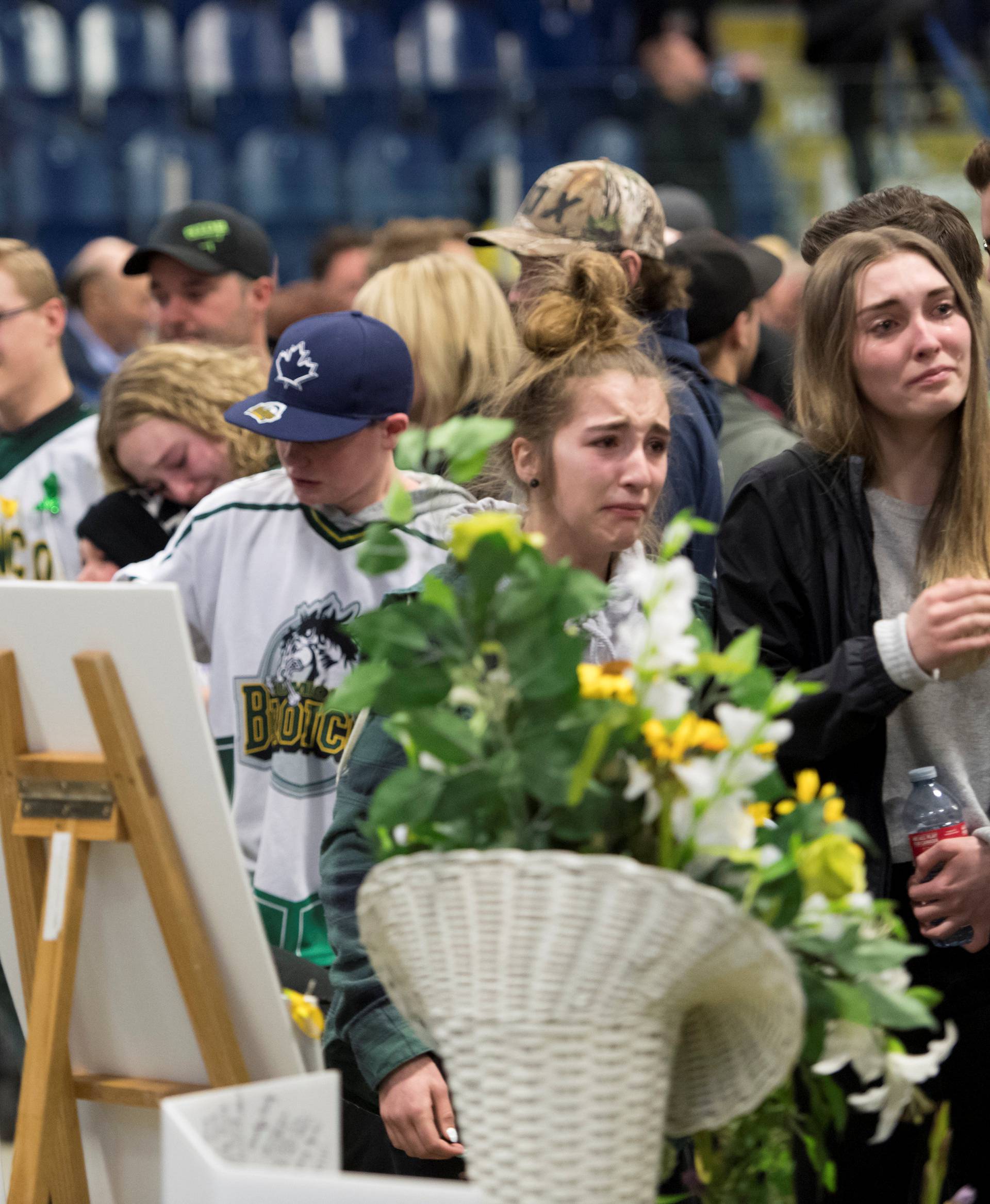 People leave a vigil at the Elgar Petersen Arena, home of the Humboldt Broncos, to honour the victims of a fatal bus accident in Humboldt