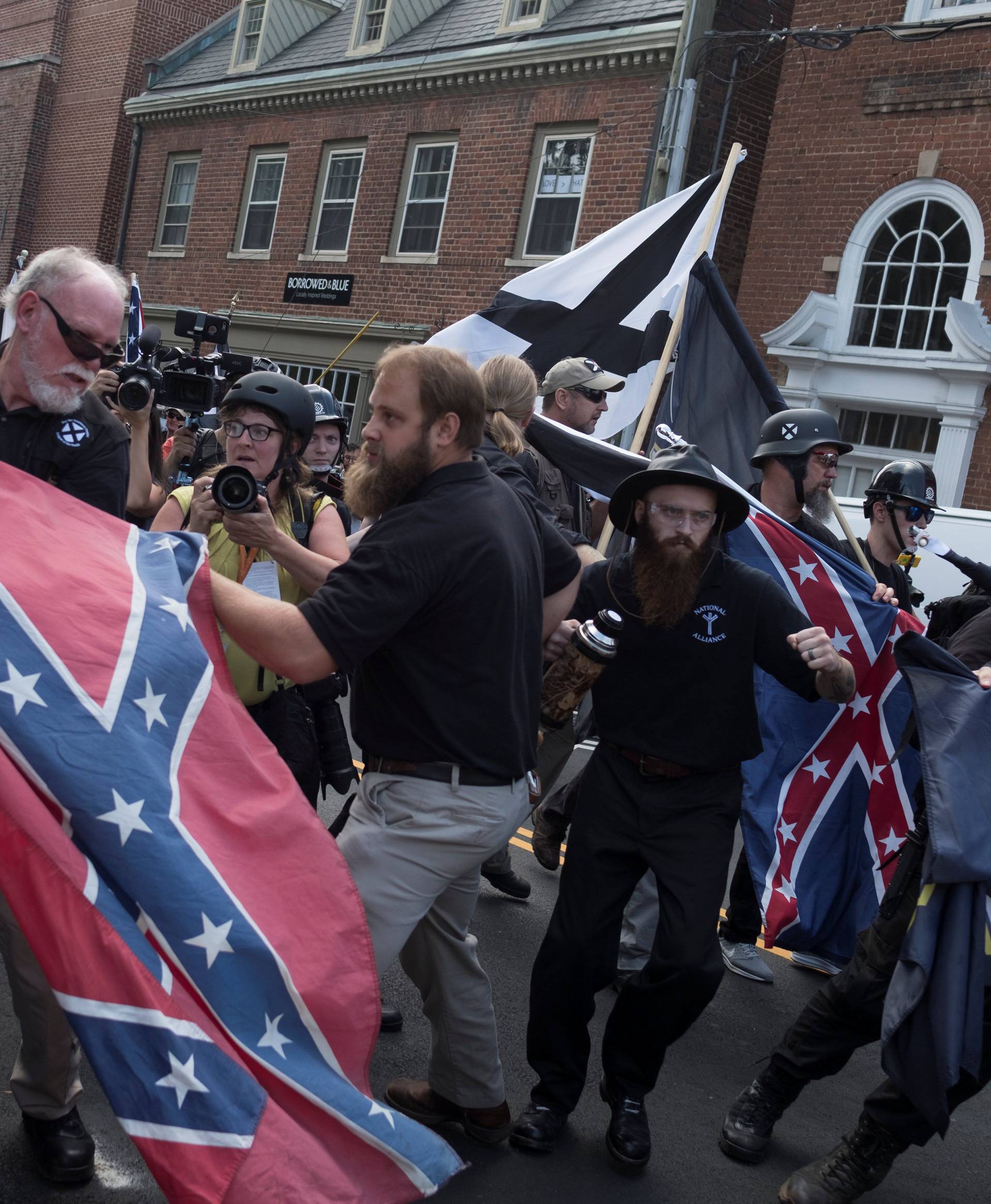 People struggle with a Confederate flag as a crowd of white nationalists are met by a group of counter-protesters in Charlottesville