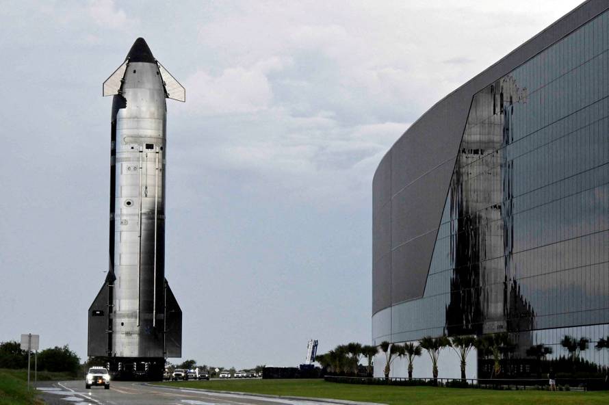 A SpaceX Starship spacecraft rolls out toward its launch pad before its 10th test flight
