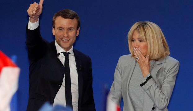 Emmanuel Macron, head of the political movement En Marche !, or Onwards !, and candidate for the 2017 French presidential election, arrives with his wife Brigitte Trogneux to deliver a speech at the Parc des Expositions hall in Paris