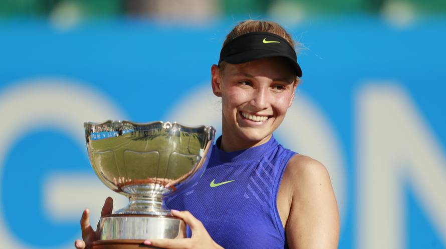 Croatia's Donna Vekic celebrates winning the final with the trophy