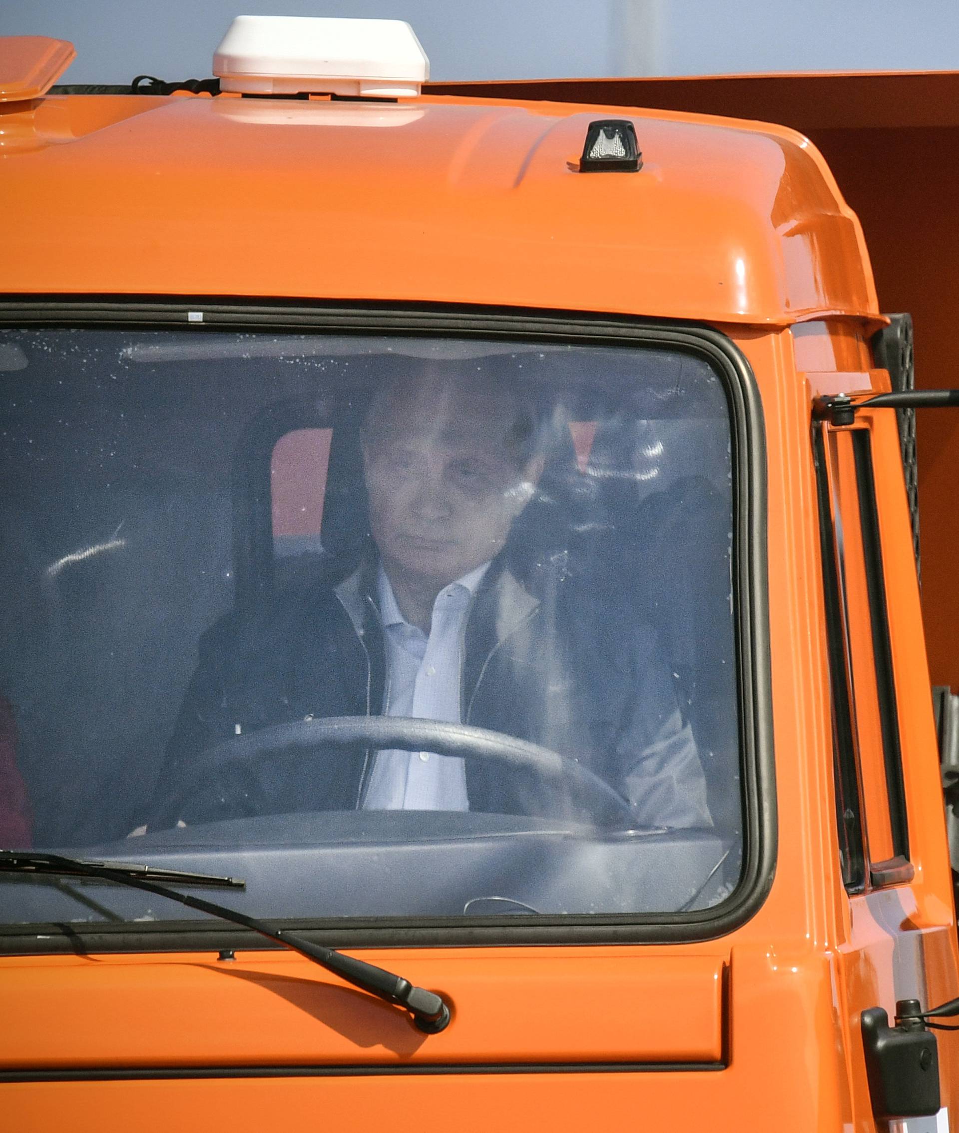 Russian President Putin drives a Kamaz truck during a ceremony opening a bridge, which was constructed to connect the Russian mainland with the Crimean Peninsula across the Kerch Strait