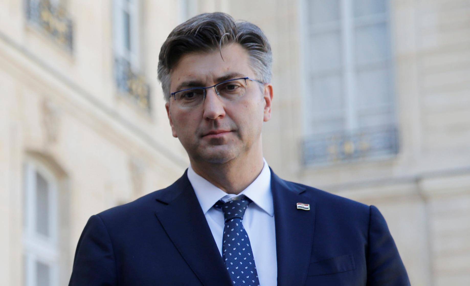 French President Emmanuel Macron and Croatian Prime Minister Andrej Plenkovic make a statement in the courtyard of the Elysee Palace in Paris