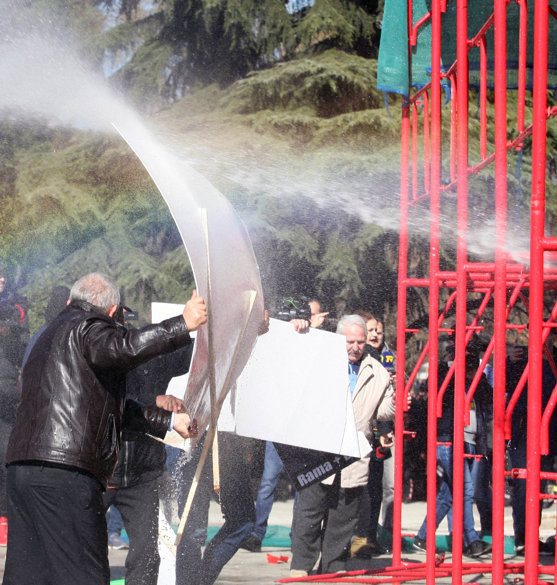 Supporters of the opposition party protest in front of a government building that houses the office of Prime Minister Edi Rama in Tirana