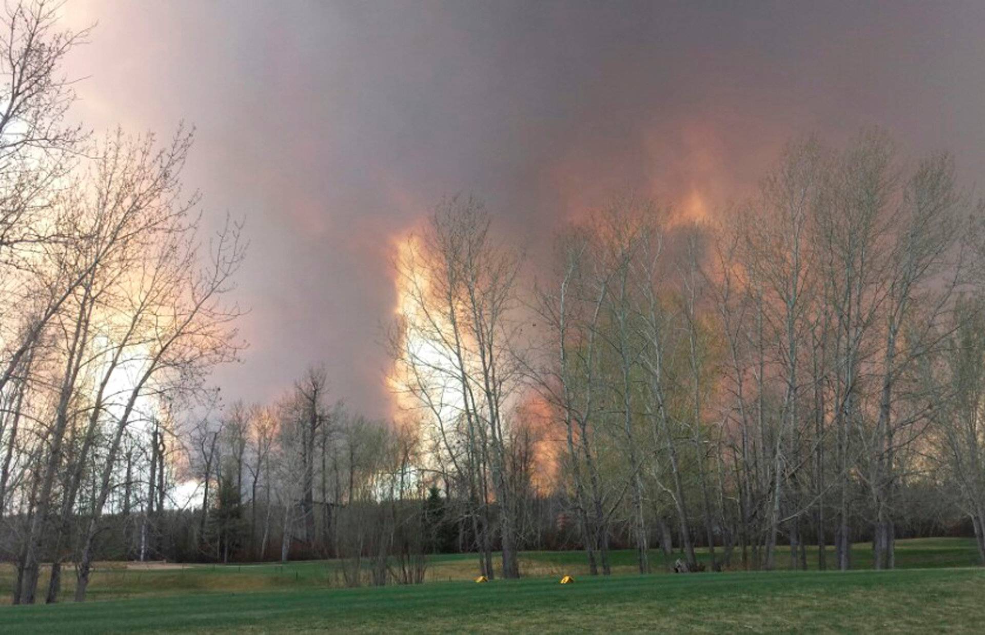 Wildfire is seen from MacDonald Island Park near Fort McMurray Alberta