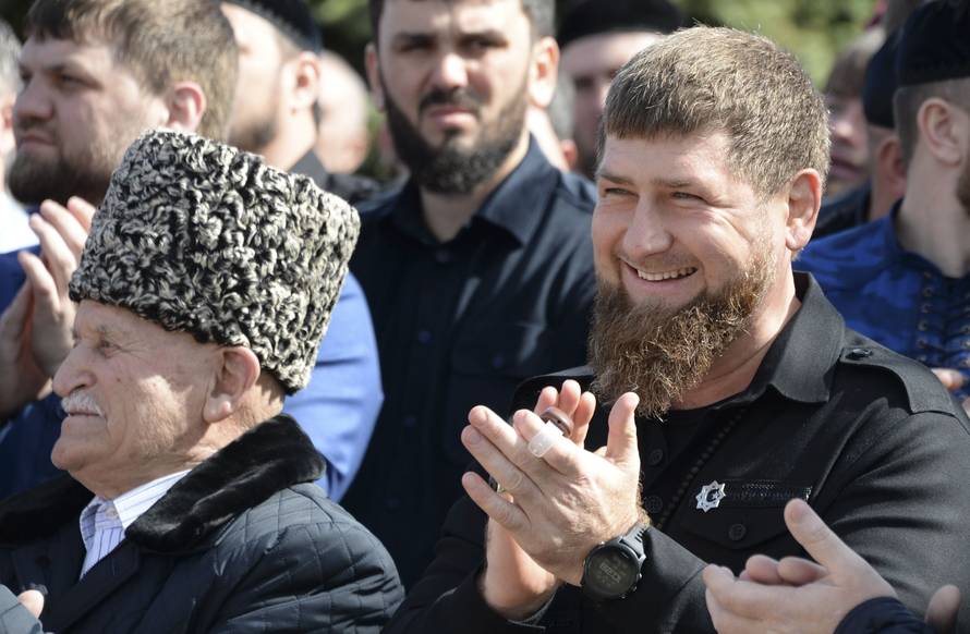 Head of the Chechen Republic Kadyrov applauds after visiting a polling station during the presidential election in Tsentoroy