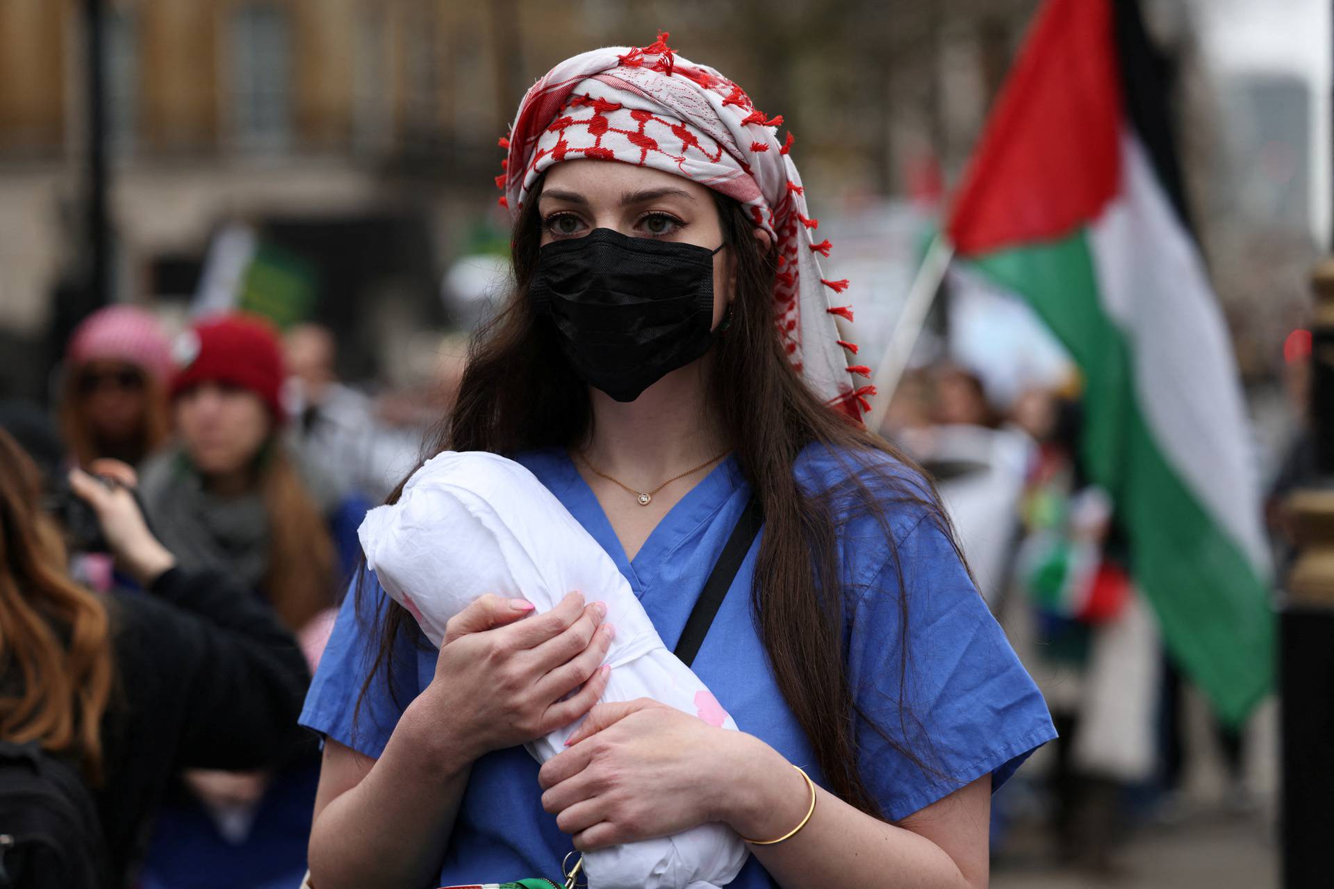 Health workers participate in a silent procession during a vigil for Gaza in London
