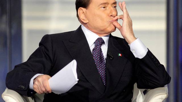 FILE PHOTO: Italy's former Prime Minister Silvio Berlusconi gestures as he appears as a guest on the RAI television show Porta a Porta (Door to Door) in Rome