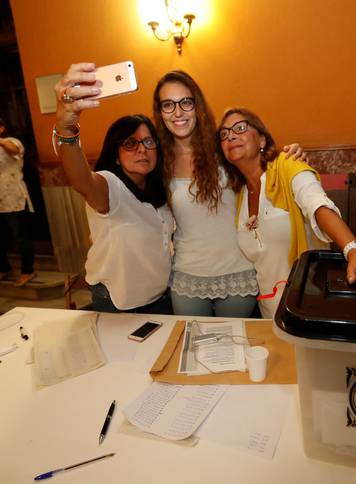  Polling station staff take a selfie as voting ended for the banned independence referendum in Barcelona