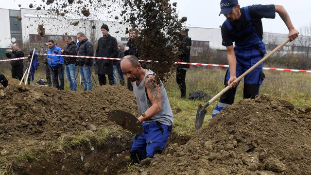 Gravediggers compete during a grave digging championship in Trencin, Slovakia