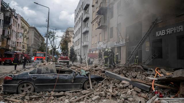 FILE PHOTO: Firefighters work at the site of a residential building hit by a Russian military strike in Kharkiv