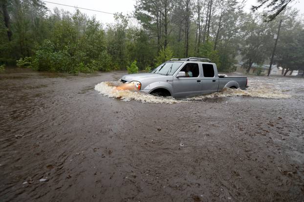 A motorist drives through high waters after Hurricane Florence swept through in North Carolina