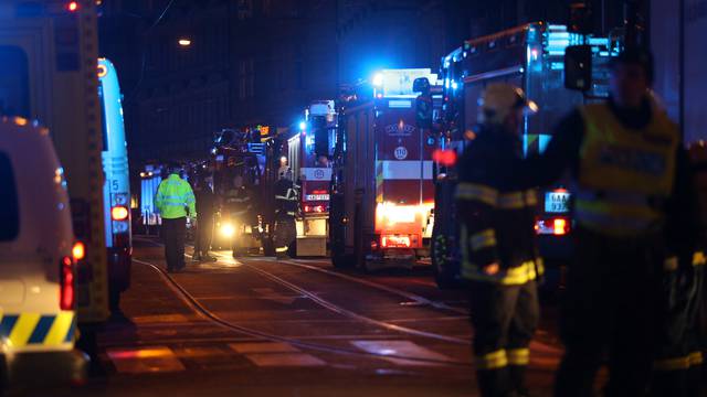 Firefighters work at the scene of a fire at a hotel in Prague