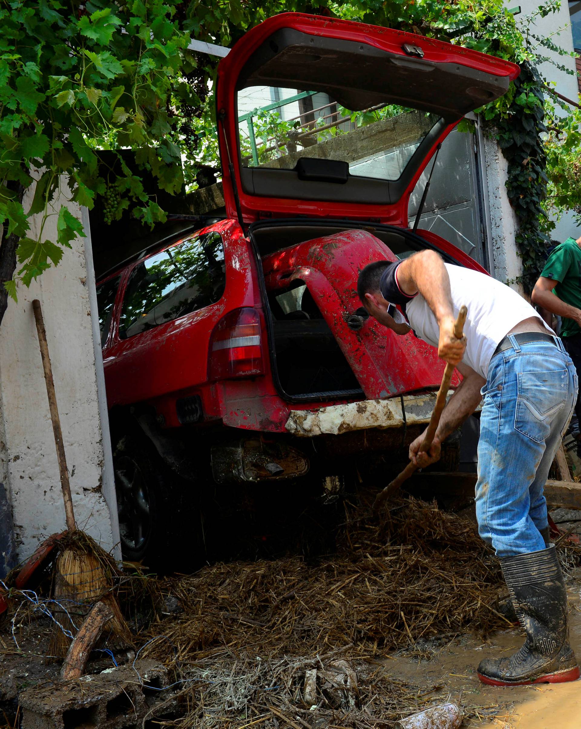 People clean up after heavy floods in Cento