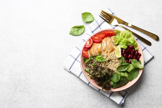 Healthy meal. Tasty vegetables, quinoa and chicken breast in bow