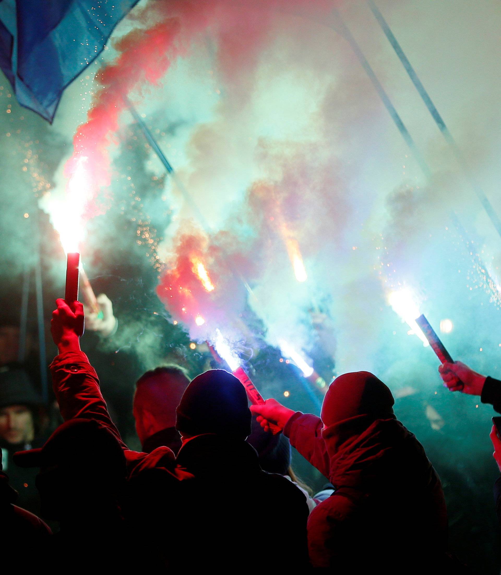 Activists of opposition parties burn flares during a rally demanding to break an agreement with Russia on the use of the Azov Sea and the Kerch Strait, in front of the parliament building in Kiev