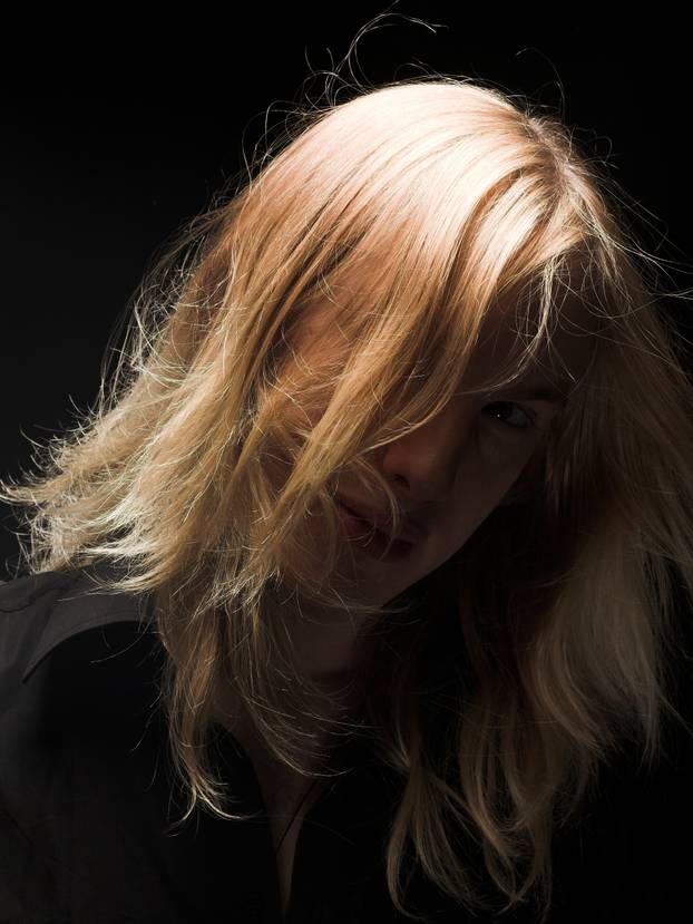 Young man with long blond hair